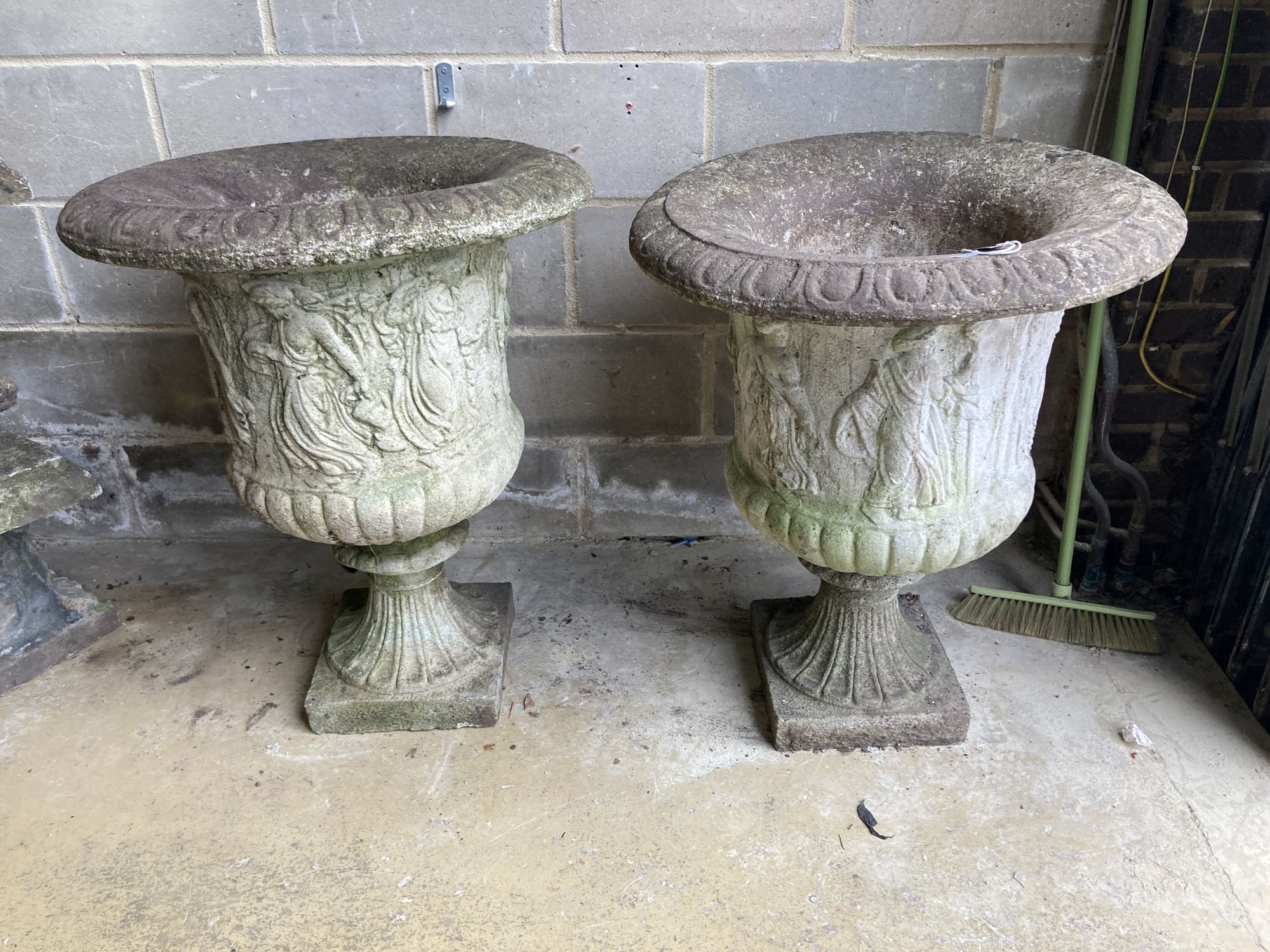 A near pair of reconstituted stone campana garden urns, larger 66cm diameter, height 85cm